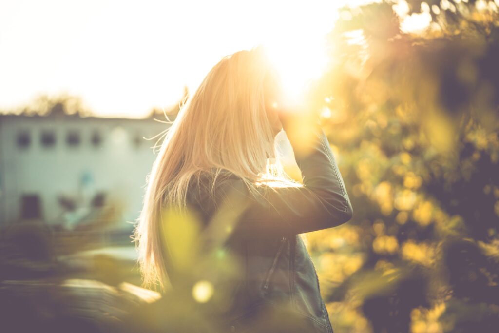 Girl in sunlight with hand in hair