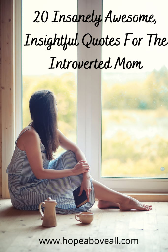 An introverted woman sitting on the floor looking out of the window with a pitcher and cup on the ground next to her and a notebook in her hand.  The title of the blog post appears at the top of the blog post:
20 Insanely Awesome, Insightful Quotes For The Introverted Mom.

