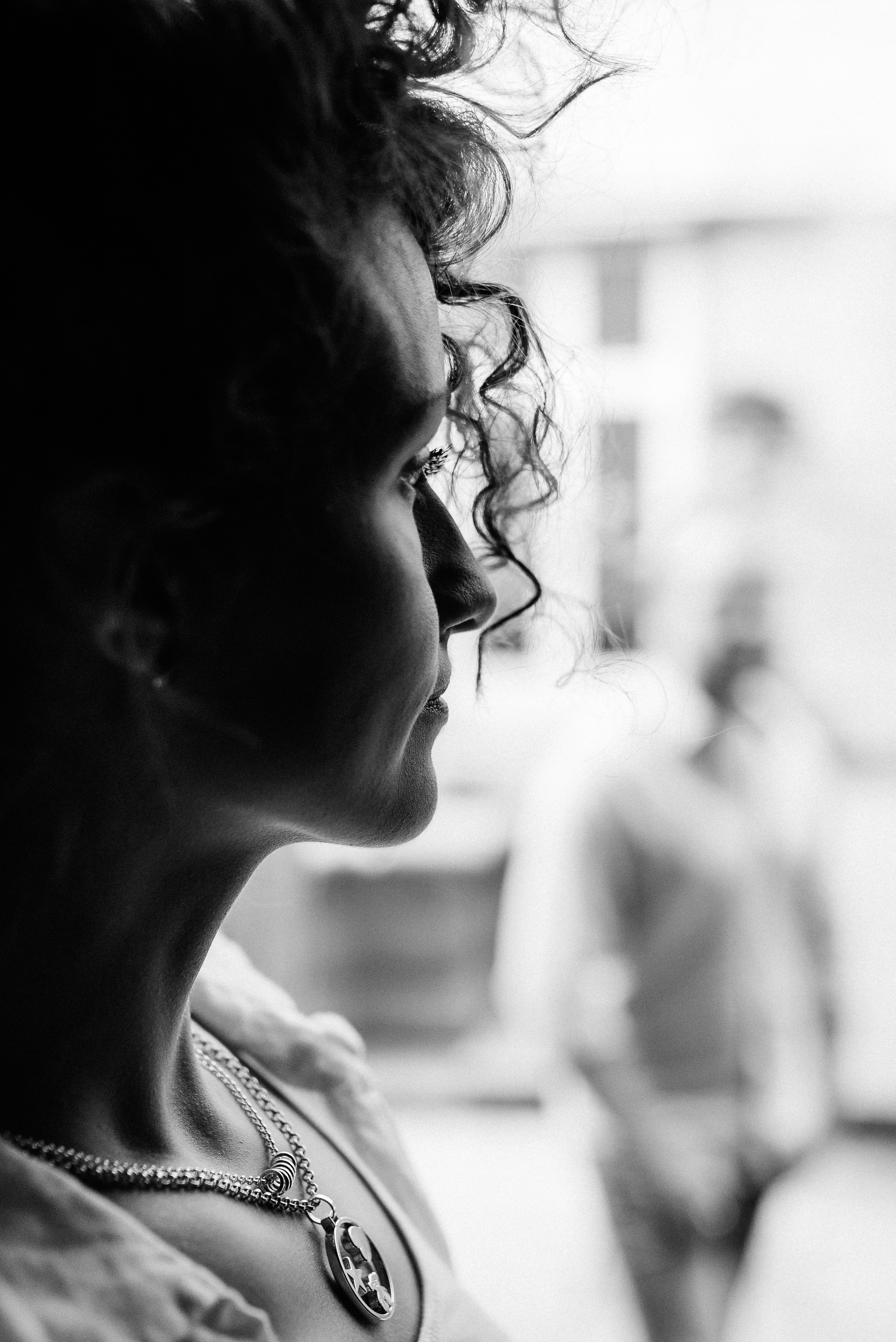 Greyscale photo of woman looking at her left side
