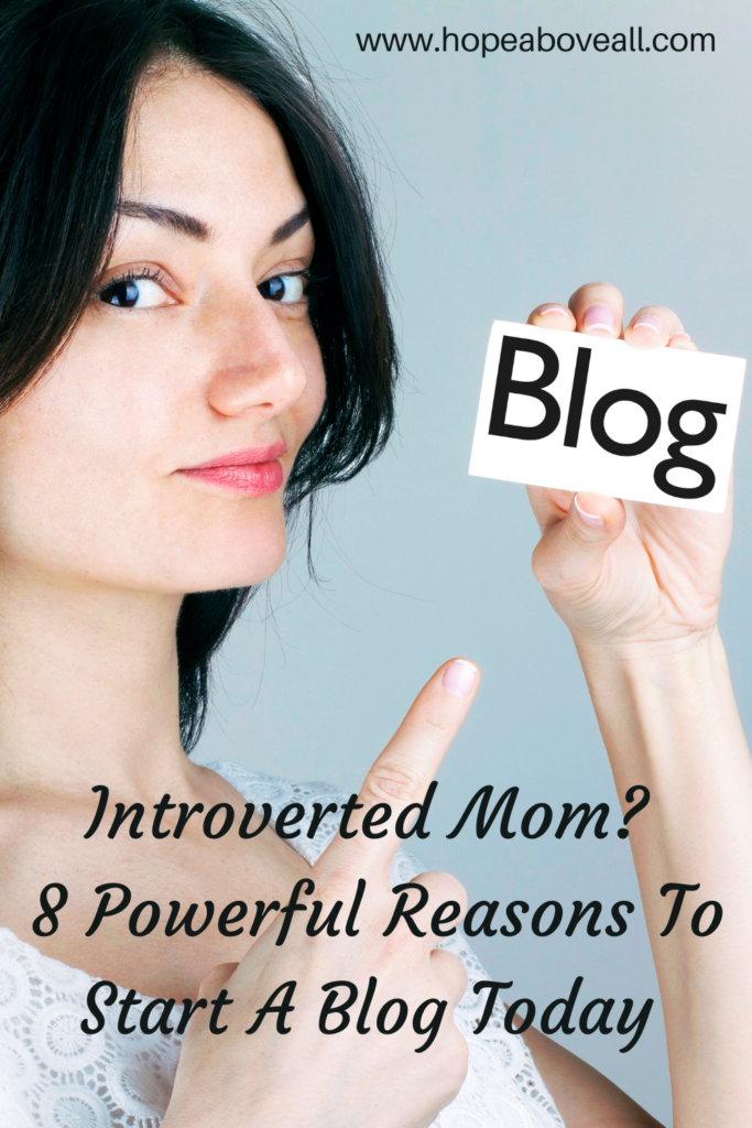 Pin with woman pointing to the word blog and blog title in black at the bottom:
Introverted Mom? 8 Powerful Reasons To Start A Blog Today