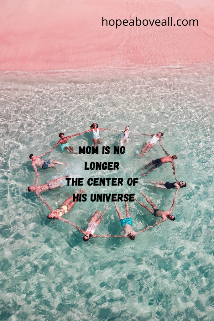People forming a circle in water by holding hands and the words, "Mom is no longer the center of his universe" are in the center of the circle