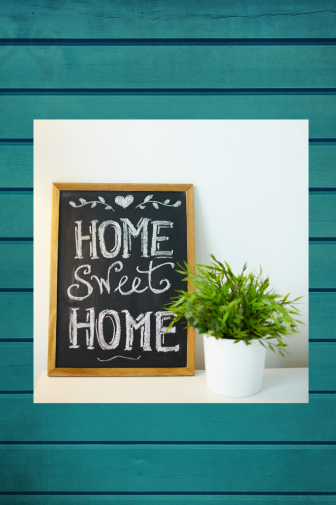 Home sweet home sign with plant and green background