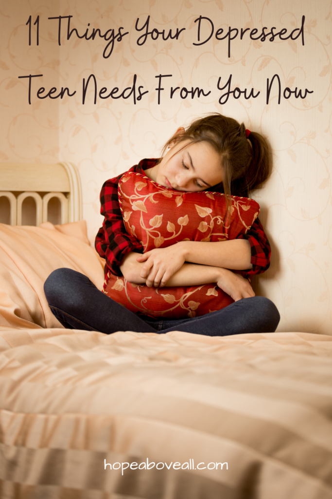 Image of a young girl sitting sadly on her bed hugging a pillow and the title of the blog post is at the top: "11 Things Your Depressed Teen Needs From You Now"