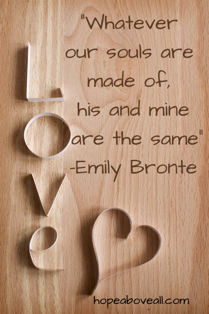 Pin with wooden background with the word LOVE and a heart made by paper and a quote by Emily Bronte written on it.