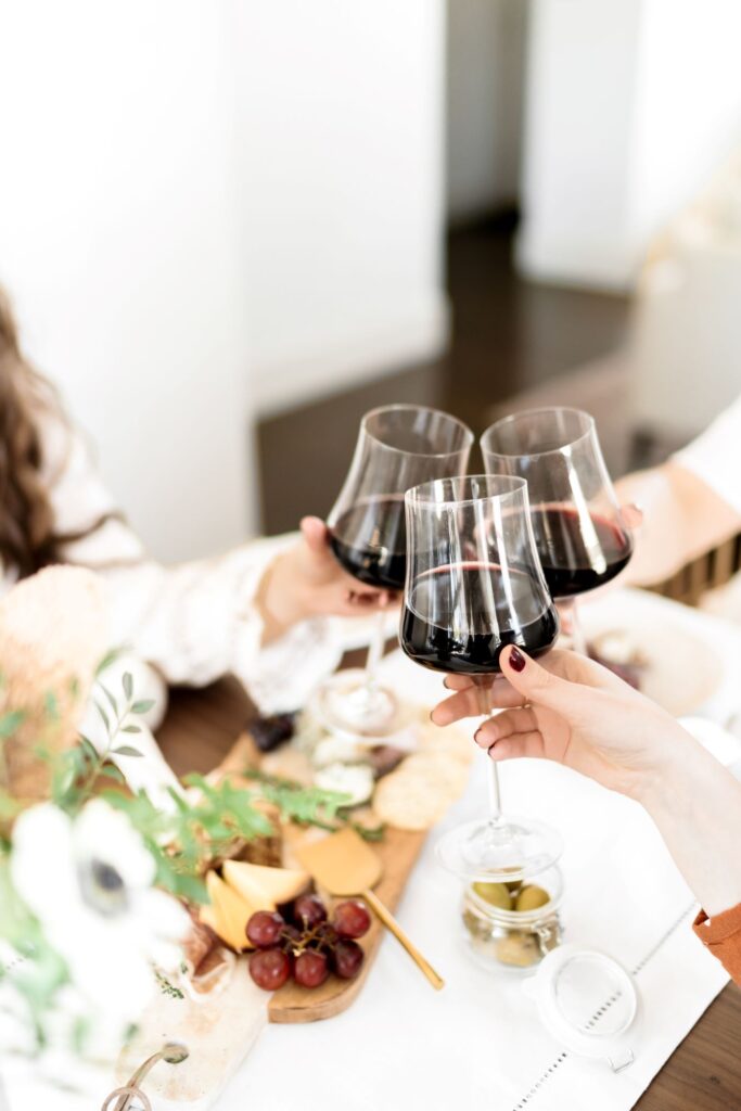 One of the easy and effective ways to help struggling moms, have a girls' night out.  Pic showing women toasting over dinner.
