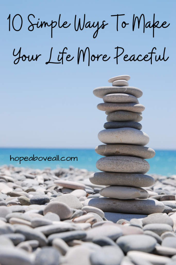 Pin with picture of zen stones on a beach, with title of pin, 10 Simple Ways To Make Your Life More Peaceful, at the top.