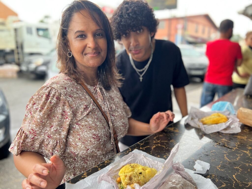 My son and I eating doubles, the most popular street food in Trinidad.