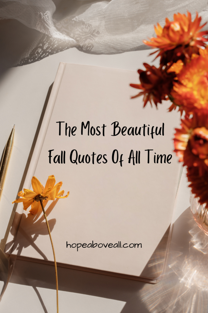 Book surrounded by Fall decor with the title of the blog post: The Most Beautiful Fall Quotes Of All Time, on it.