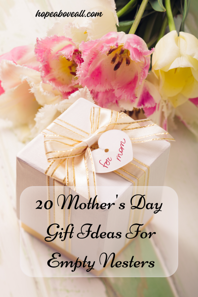 Present beautifully wrapped in white paper and gold-trimmed ribbon and pin title: 20 Mother's Day Gift Ideas For Empty Nesters, is at the bottom