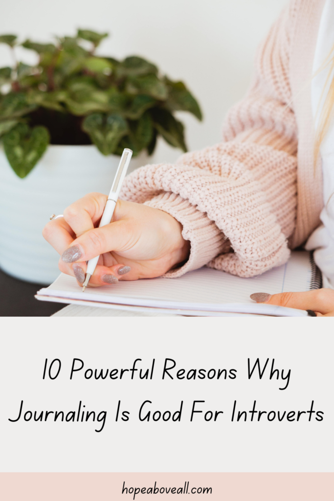 Pin with photo of a woman wearing a sweater writing in a journal
Pin title: 10 Powerful Reasons Why Journaling Is Good For Introverts
is at the bottom

