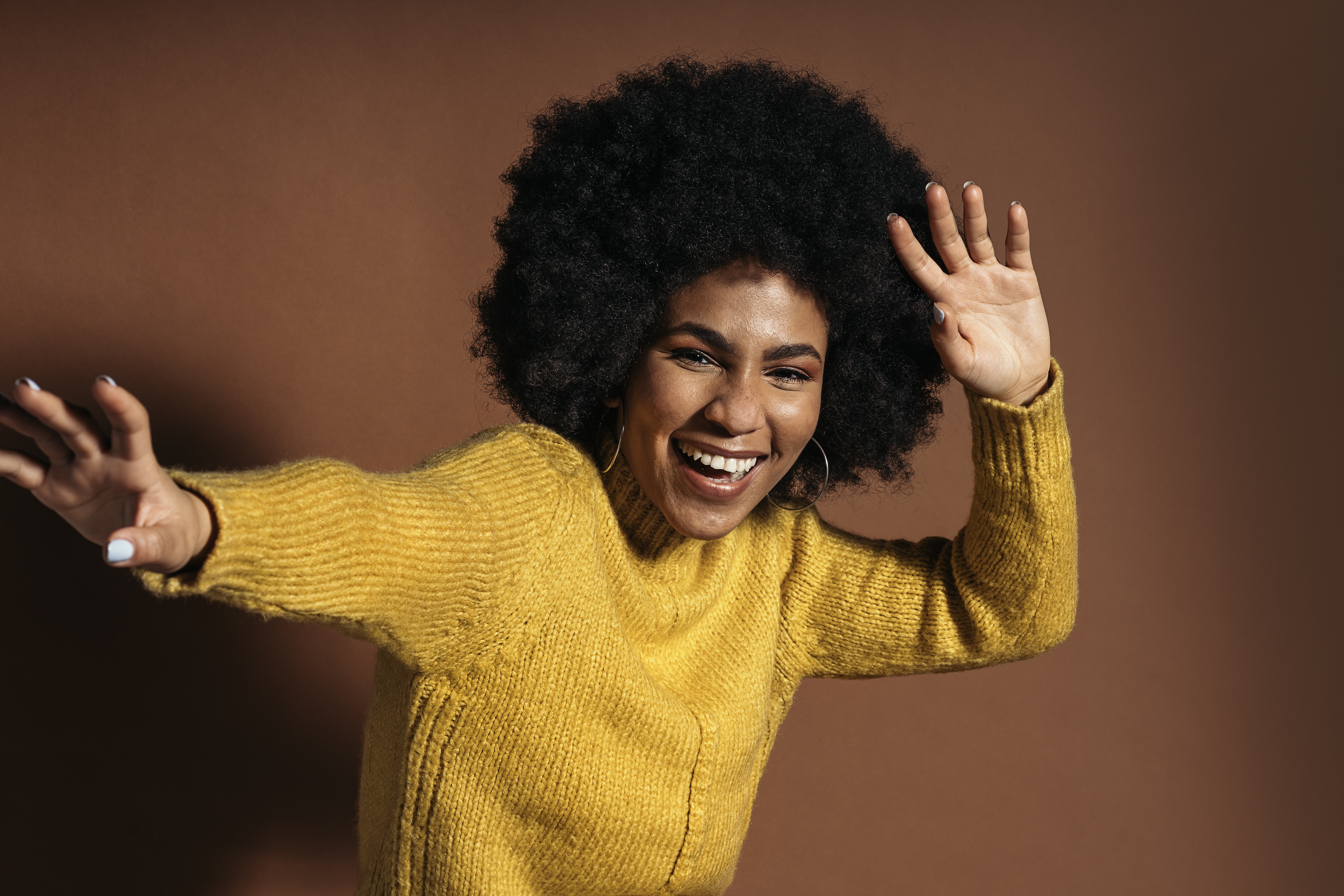 Woman in yellow knit sweater smiling